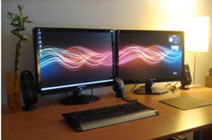 a well organized dual monitor workstation with all the accesories